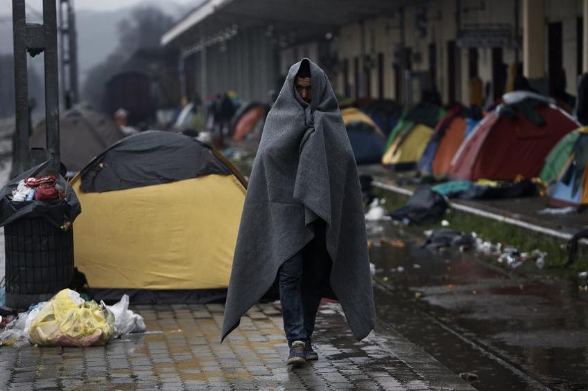 epa05204373 A refugee wrapped with a blanket at a refugee camp at the border between Greece and the Former Yugoslav Republic of Macedonia (FYROM), near Idomeni, northern Greece, 10 March 2016. After Slovenia, Croatia, Serbia and Macedonia have sealed their borders to the migration flow, tens of thousands of people are left stranded in Greece, where most migrants enter the European Union to continue on to wealthier countries in Northern Europe. Greece estimates that more than 25,000 migrants are presently on its territory, with more than half stuck at the makeshift camp Idomeni, on the border with Macedonia.  EPA/YANNIS KOLESIDIS